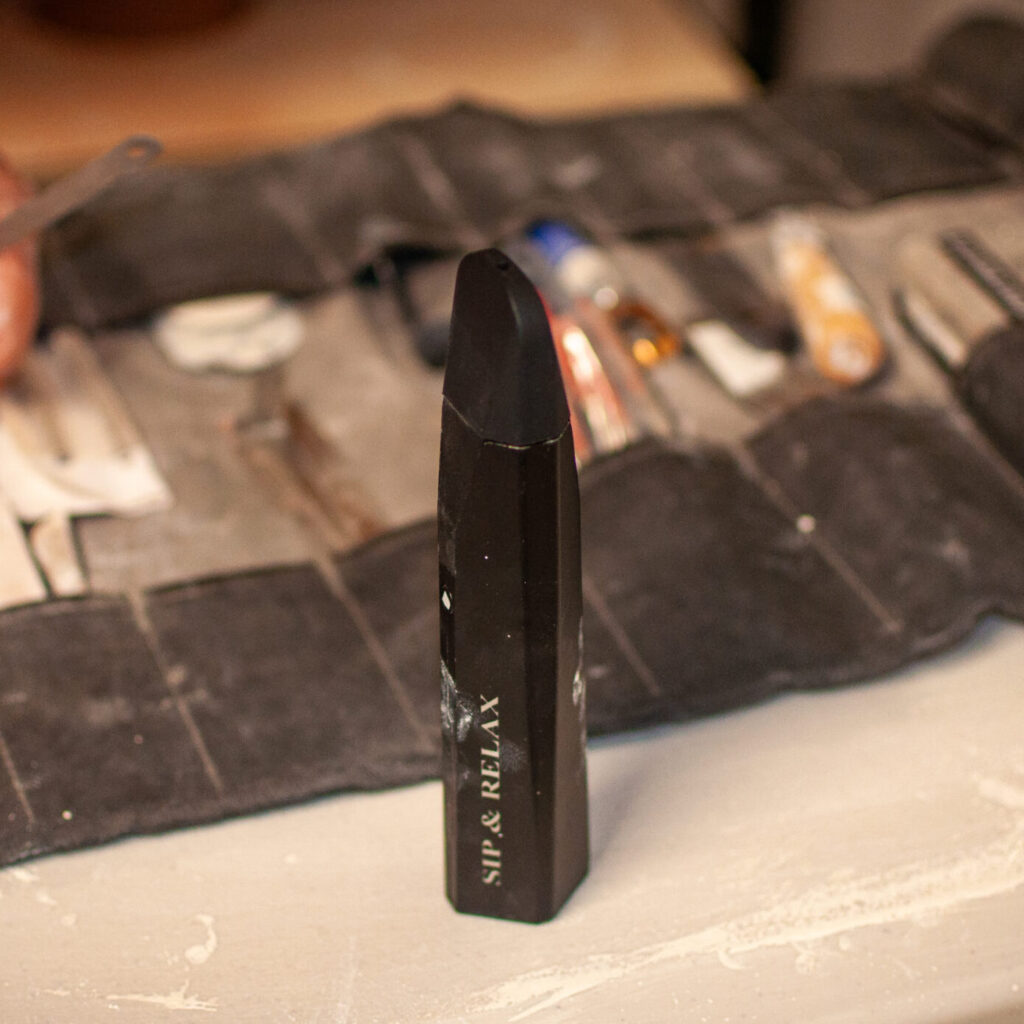 Mixturus in front of a pottery tool bag